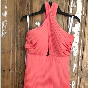 Coral tea length pleated chiffon dress